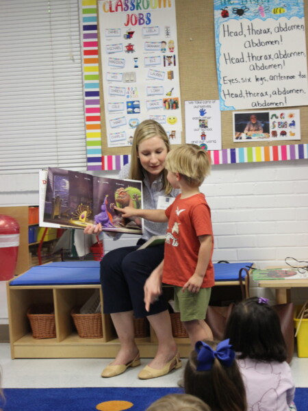 A teacher reading a book to a group of children in a classroom at River Oaks Baptist School