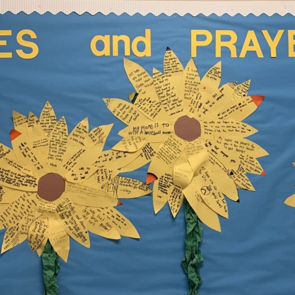 A bulletin board with yellow flowers on it with Hopes and Prayers Quotes