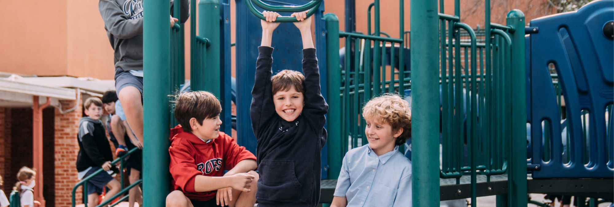 A group of children playing on a playground structure at River Oaks Baptist School