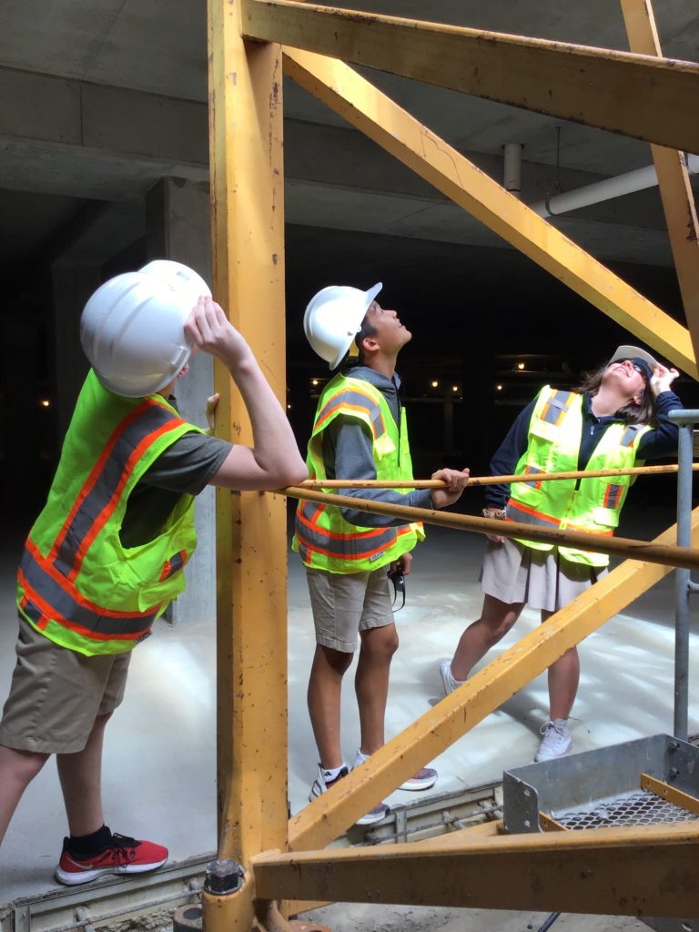 A group of students of ROBS in safety vests visited on a construction site