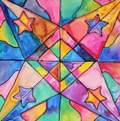 A picture of a colorful kite that is in the shape of a star