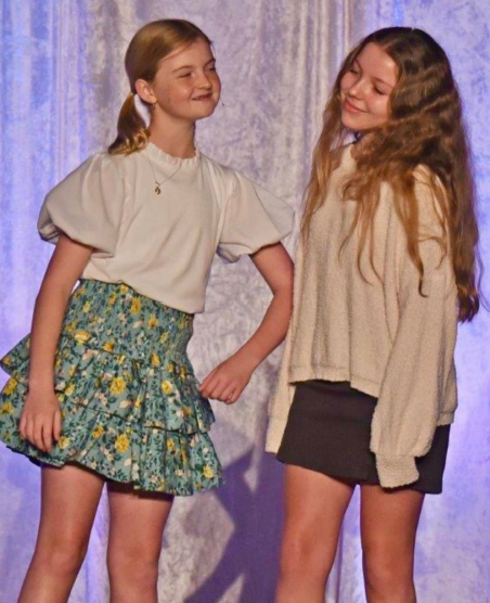 Two young girls students performing on a stage at River Oaks Baptist School